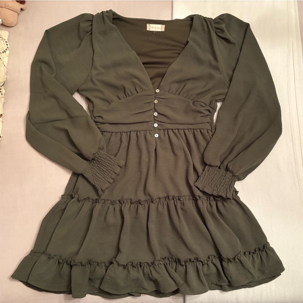 green deep v neck altar’d state mini dress with a cinched waist and tiered skirt
